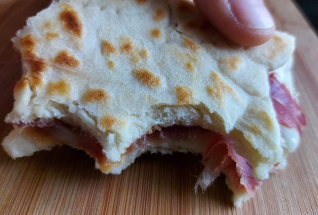 A traditional piadina filled with ham, after a couple of bites!